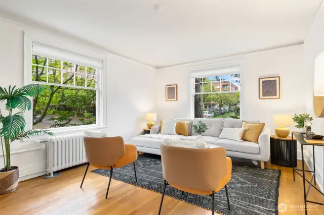 Gracious and spacious living room that glows with natural light from 2 sides in this corner home!