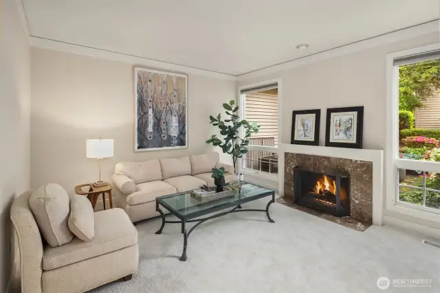 Step inside to a bright & spacious living area featuring vaulted ceilings, large windows & two cozy fireplaces.