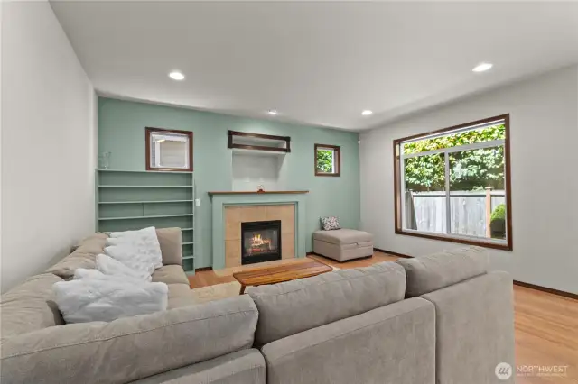 Living room features many windows and gas fireplace