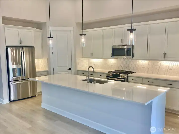 Refrigerator and gas range included.