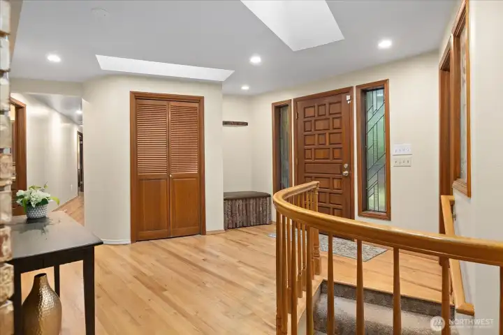 Skylights stream in lots of natural light into your entry way providing a warm welcome to  you & your guests. A coat closet is  conveniently located next to a built in bench offering ease as you come and go.