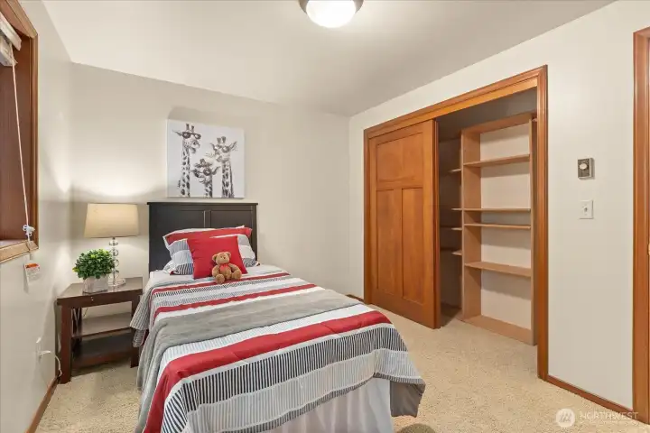 Your 2nd bedroom. With multiple heating options (heat pump, ductless with AC & wall  units), climate preferences are easily accommodated. Functional built-ins elevate bedroom storage, making wardrobe organization simple and elegant.
