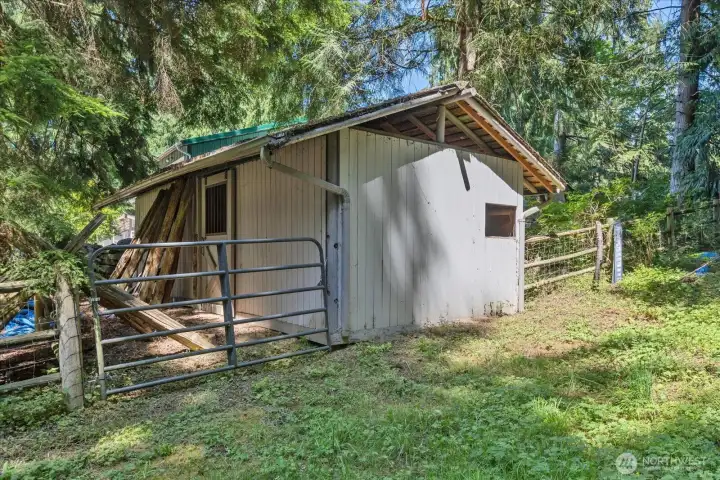 A 2 stall stable with a small pasture area for grazing.