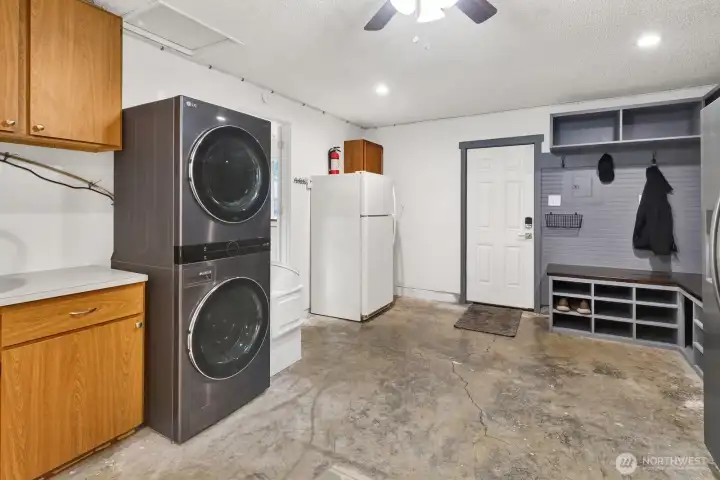 The bonus room features a newer washer/dryer and custom cabinetry to utilize the space as a mud room (with access to the backyard)