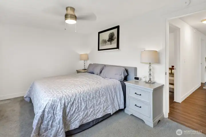 The primary bedroom is large and bright