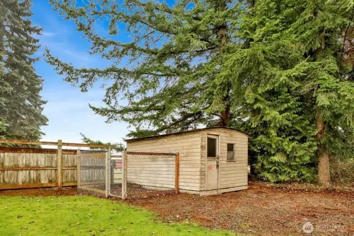 The yard features a dog run