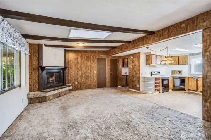 The kitchen opens onto the cheerful living space.