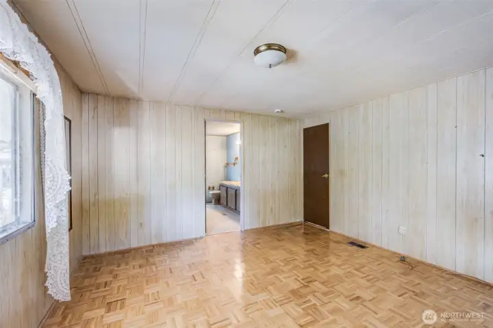 Another view of the primary bedroom showing the bathroom access.
