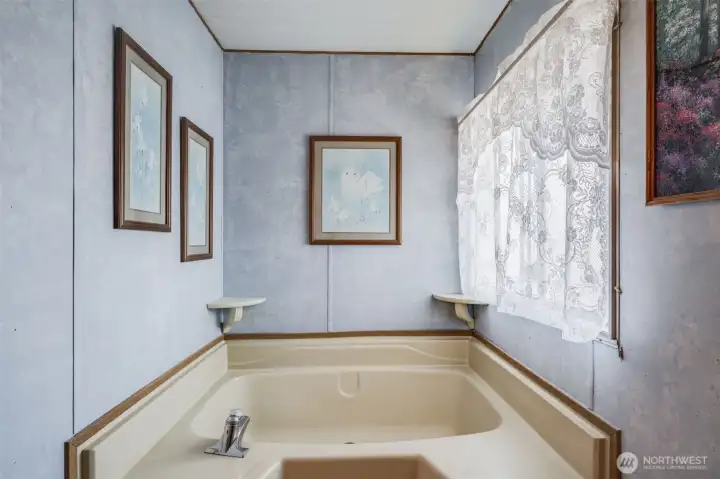 Relax in this primary suite soaking tub.