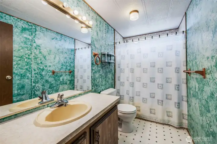 Off the hallway is a well appointed guest bathroom with a combo tub and shower.