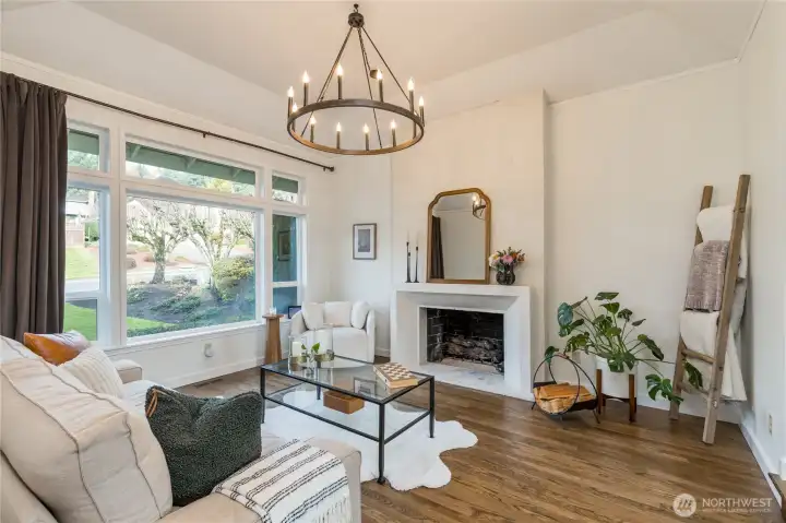 Formal living room with rich hardwood flooring and custom lime-plaster fireplace surround