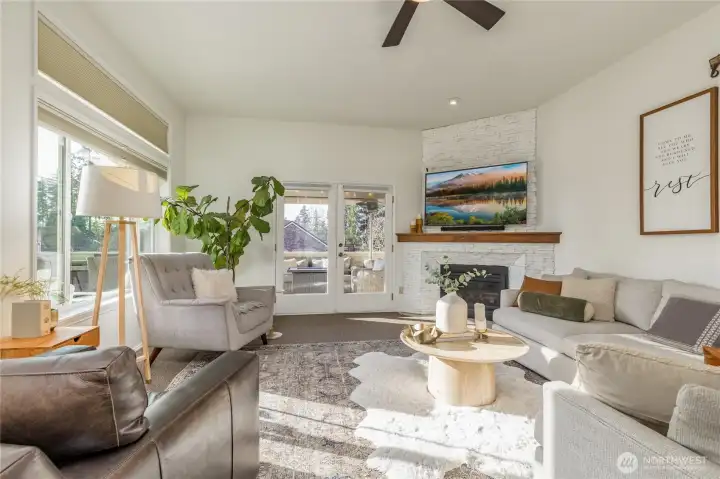Gorgeous family room with gas fireplace, French doors out to the covered deck