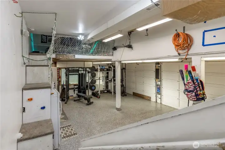 Attached garage has durable epoxied floor. Excellent use of the vertical space with loft for play area or extra storage.