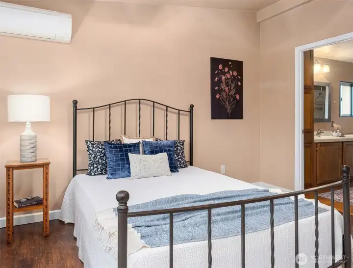 Primary bedroom with en-suite bath seen through doorway.