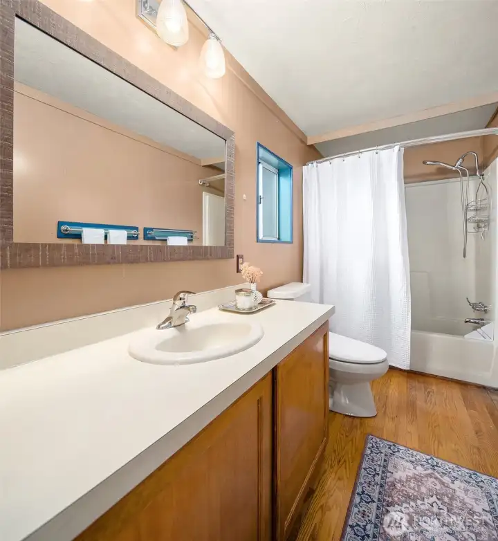 Big bath with lots of cabinets and countertop space. Tub/shower.