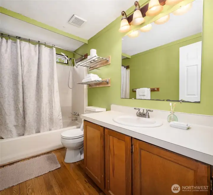 Second bath room between bedrooms on western end of home. Tub/shower.