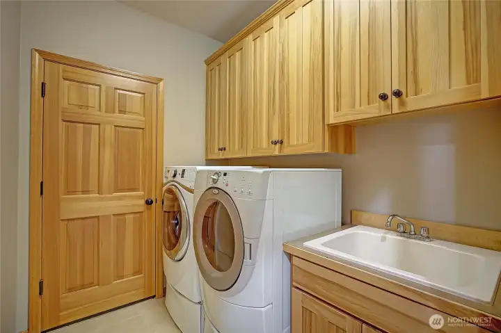 Laundry room with a sink.  Access to the three car garage.
