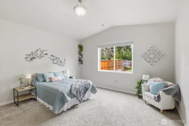 Primary bedroom is large with vaulted ceilings