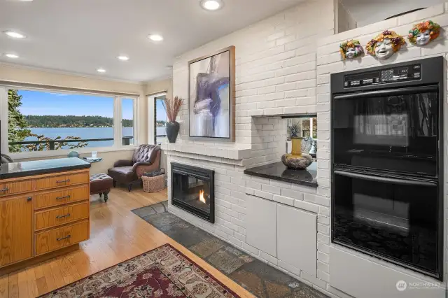 Kitchen view toward lake with fireplace.