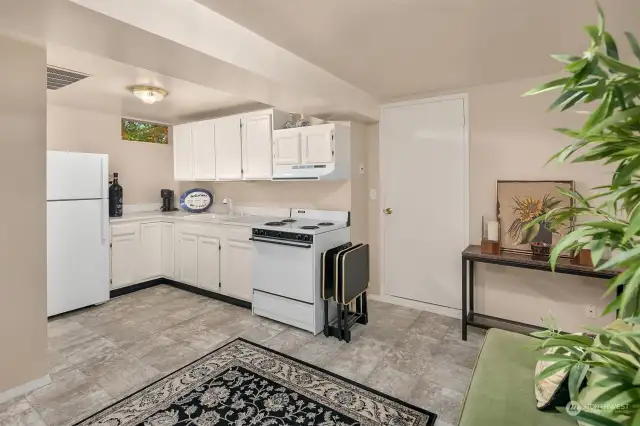 Lower level kitchen with seating area and dining space(lower left foreground.