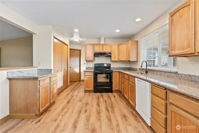 This is a picture of the kitchen in Unit B. The kitchen is open and spacious, and has granite countertops.