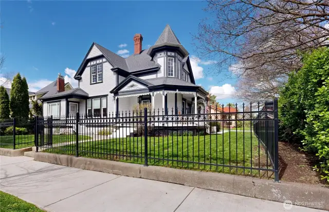corner view with new wrought iron fence