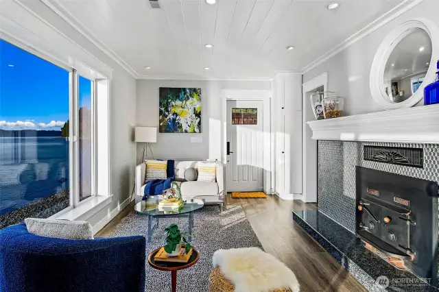 Inside 7316 Eastside Drive NE, the Beach House is bathed in natural light and Sound views. Crisp millwork, a cozy fireplace, and expansive windows bring coastal charm and calm to this refined retreat—steps from the tide. Every room offers a connection to the water, turning daily life into a seaside escape.