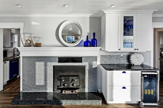 A closer look at the heart of 7316 Eastside Drive NE. The Beach House blends warmth and elegance with custom cabinetry, artisanal tilework, and a wood-burning fireplace—ideal for storm-watching or quiet evenings by the Sound. Thoughtful design meets timeless craftsmanship in every corner.