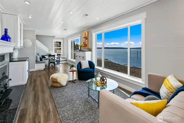 A front-row seat to sunset at 7316 Eastside Drive NE. This built-in banquette dining area offers cozy gathering space with wide-open views across Caledonia Cove. Whether it’s morning coffee or a candlelit dinner, the water is always on the menu.