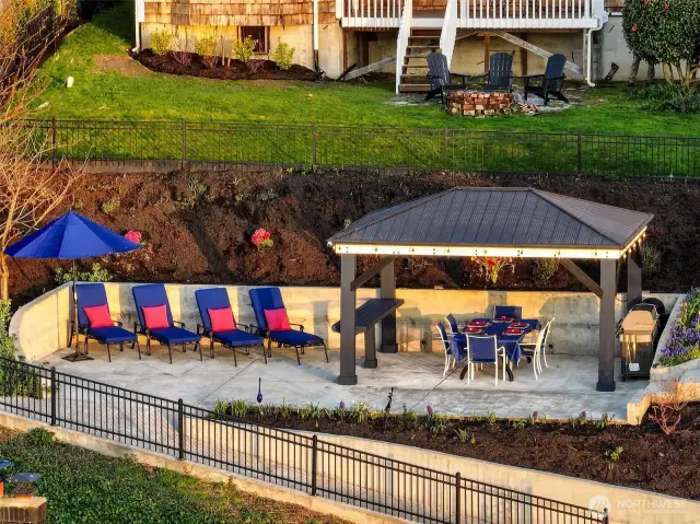 Gather under the Soundscape Lounge at 7316 Eastside Drive NE. With seating for eight, a built-in grill, and world-class views, this covered terrace is made for memorable meals and effortless entertaining. From brunch to bonfire, this is where the magic happens.