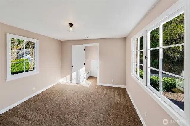 Classic lines and coastal warmth define the exterior of 7314 Eastside Drive NE. Shingled siding, a welcoming covered porch, and thoughtful architectural details reflect timeless Cape Cod style—nestled above the Sound in quiet privacy. A home with heritage and heart, ready for its next chapter.