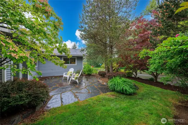 Beautifully landscaped backyard with patio and storage shed.