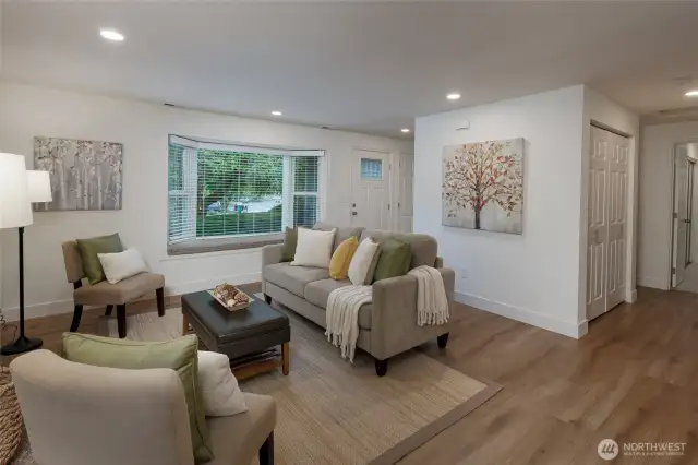 Living room has a window seat, perfect for reading a book.