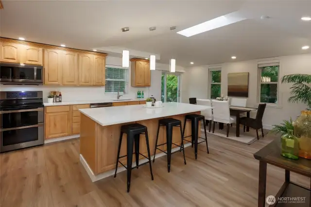 Amazing kitchen is a chef's delight with new quart countertops, newer stainless steel appliances, tons of storage, skylight, designer lighting and generous dining space.