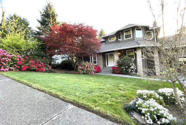 This photo was provided by the seller to show how beautiful the front yard will look with blooming flowers during spring.
