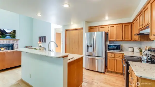 The island has an undermount stainless steel sink and a 3 spot eating bar.