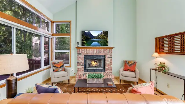 The family room has a tall vaulted ceiling plus a gas log fireplace.