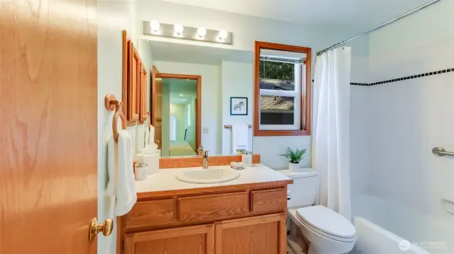 The full hall bath is at the end of the hallway.