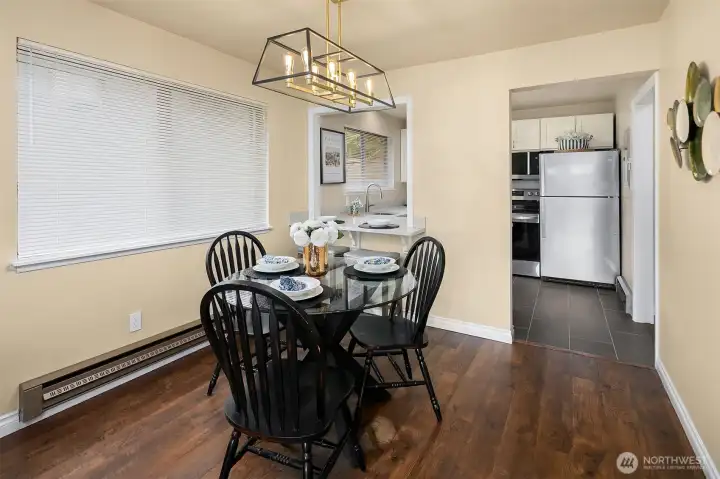 Dining room with new light fixture and breakfast bar at kitchen pass through.