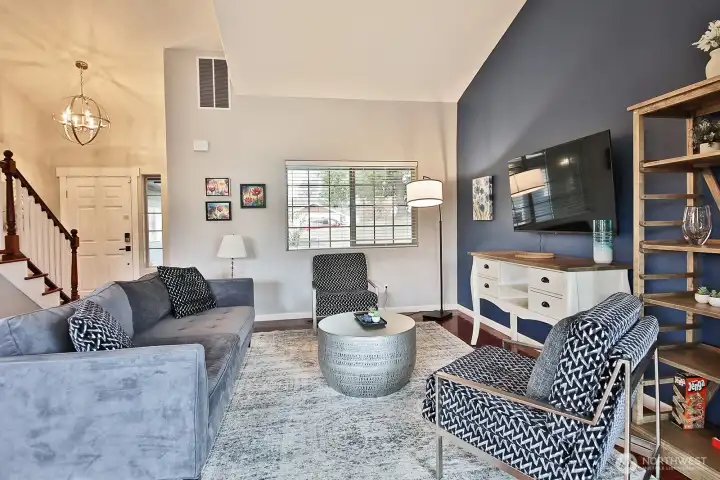 You will be greeted by light and bright Family Room featuring Vaulted Ceilings. Entering the home looking back at front door...stairs lead to upstairs (2) bedrooms and huge bonus room over the 2-car garage.