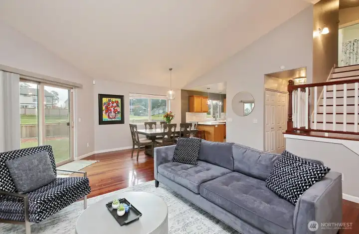 Coming back down the stairs enjoy light and bright family room, spacious area enhanced with Vaulted Ceilings...slider to outside, fully fenced backyard to the left. Now let's head towards the laundry room...which is down the hallway behind the stairs (same hallway that leads to primary suite).