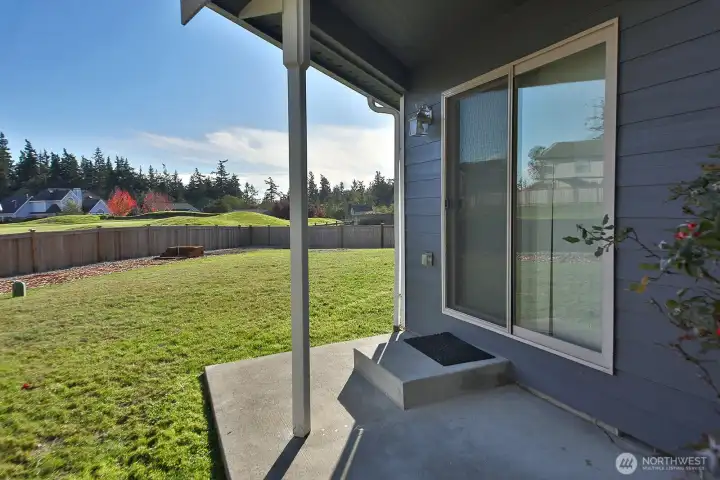 The small covered area outside of the slider to the fully fenced backyard. To the left is the shed up next!