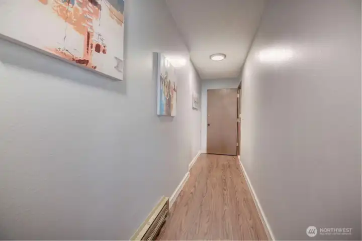 Hall way leading out to stairs and front entry