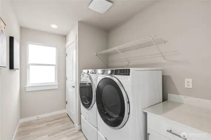 Laundry room with storage, located upstairs. Photo rendering is representational. Actual home is under construction and finishes, elevation, and paint colors may vary. See site agent for details.