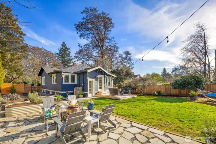 Multiple vegetable beds. Fire. pit and patio furniture.