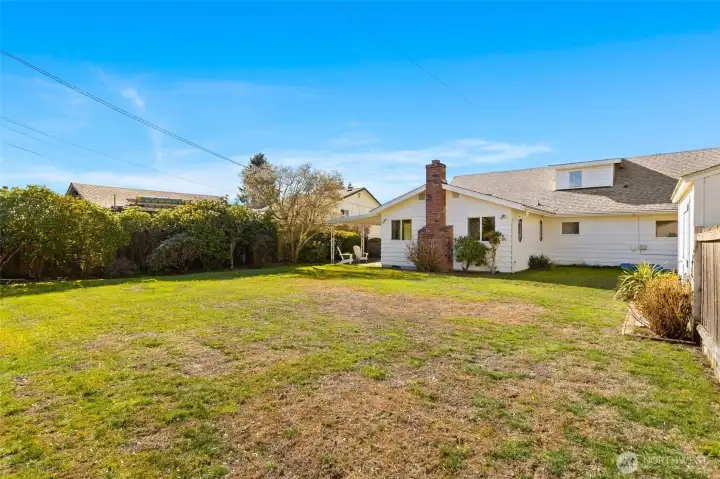 Looking to the house from the back corner of the yard, where there is an additional parking spot off the alley!