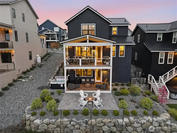 Exterior twilight view of home and outdoor living space.