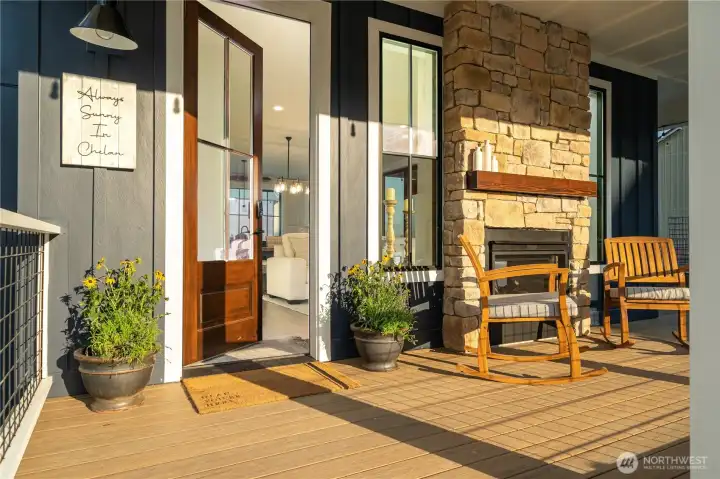 Front door entry with engineered wraparound porch and double sided fireplace.