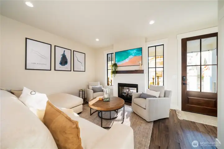 Main level living room with double sided fireplace.