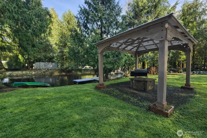Charming gazebo area overlooking the water, perfect for relaxing or entertaining in a serene outdoor setting.
